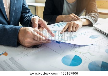 Team work process. young business managers crew working with new startup project. labtop on wood table typing keyboard texting message analyze graph plans.