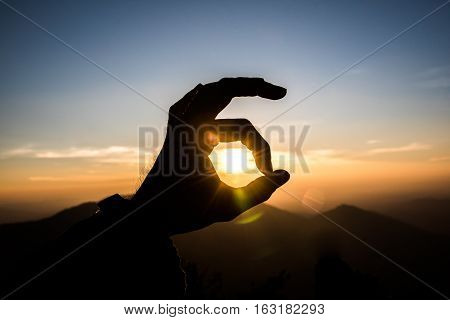 image Ok hand sign silhouette at sunset