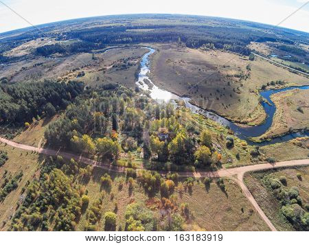 Aerial view of an abandoned church and cemetery near the river Volchina
