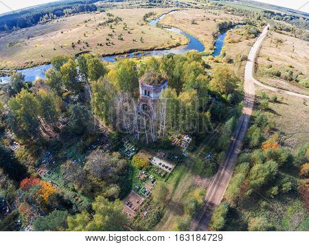 Aerial view of an abandoned church and cemetery near the river Volchina
