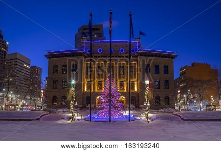 An urban park in Calgary at night all decorated for Christmas with beautiful Christmas lights.