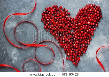 Heart of berries red heart of cranberry love and health concept top view