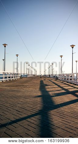 View of a wooden pier on the sea at sunset