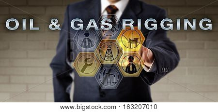 Engineer in blue suit activating OIL & GAS RIGGING on a virtual control screen via touch. Fossil fuels metaphor and energy industry concept for equipment and operations deployed to drill a wellbore.