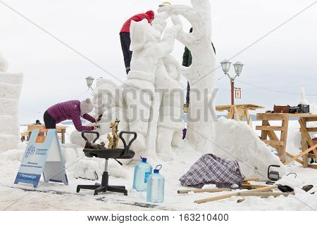 PETROZAVODSK, RUSSIA - FEBRUARY 20TH, 2016: masters sculpt a snow sculpture on the International Winter Festival 