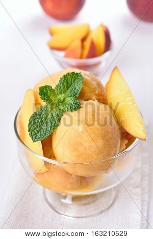Apricot peach ice cream in glass bowl