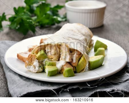Homemade fajitas with chicken meat and avocado