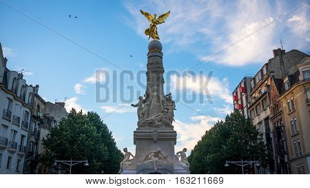 Sube fountain in city center of Reims with golden angel, autumn France