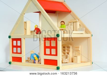 Girls dollhouse with small furniture isolated on white background