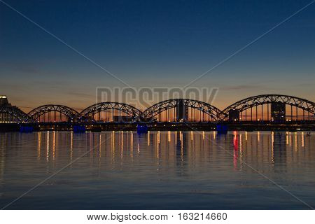 Night panoramic scene in Riga, Latvia at river Daugava