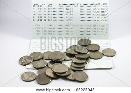 Many coin on the book bank on white background.
