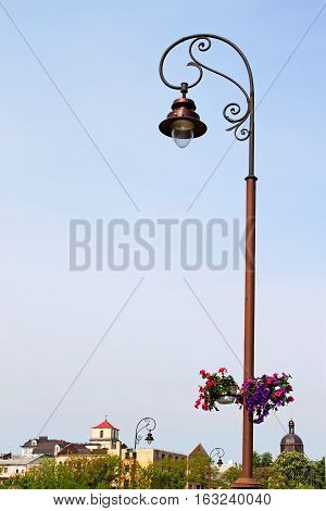 Lantern with flowers and town in Kamjanets-Podolsk, Ukraine