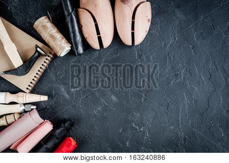 cobbler tools in workshop on dark background top view mock up.