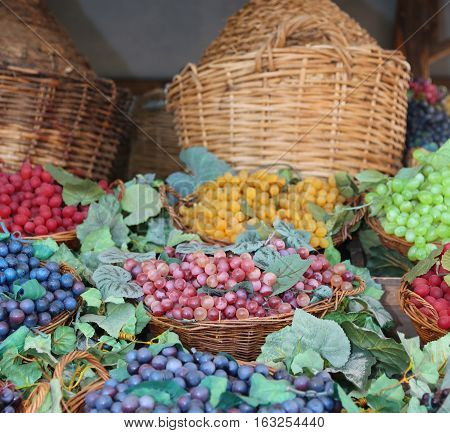 Bunches Of Ripe Grapes And Carboys In The Background