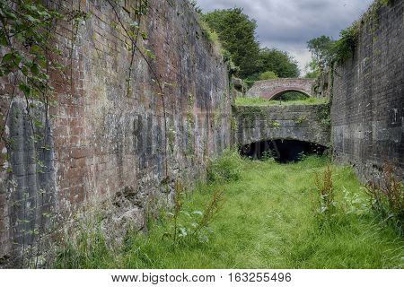 Inside Siddington Second Lock with Upper Siddington Bridge Thames & Severn Canal Cirencester Gloucestershire