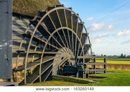 Closeup of the paddle wheel of an old hollow post mill in a Dutch polder. The mill was built in 1700.