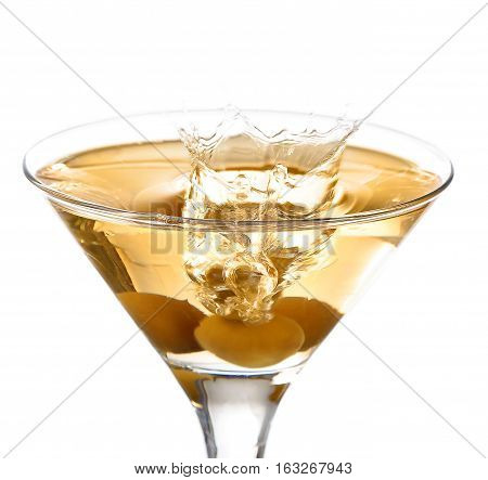 A Martini Glass On A White Background; The Water Ripples And Splashed As A Green Spanish Olive With