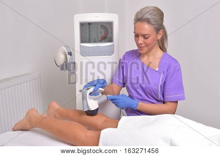 Young beautiful woman gets professional skin treatment in a beauty clinic. Body shaper