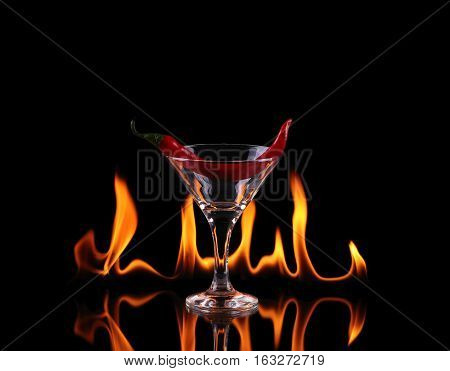 Hot Chili Pepper In A Martini Glass With A Fire On A Black Background