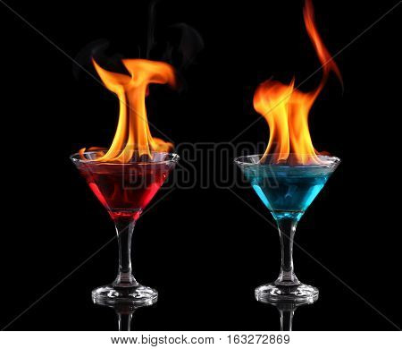 Flaming Red And Blue Cocktails Over Black