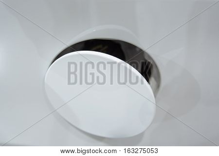 Open fuel tank flap. Modern white car closeup fragment