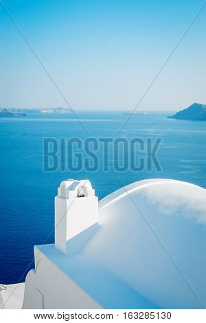 White building against blue sky and sea in Santorini island Oia Greece