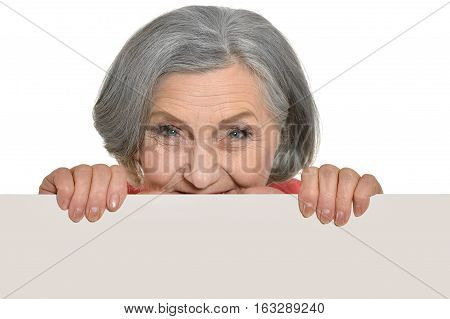mature woman holding empty placard, against white background