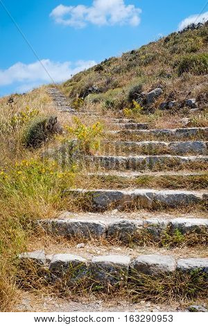Stone staircase on the green grass in Santorini island Oia Greece