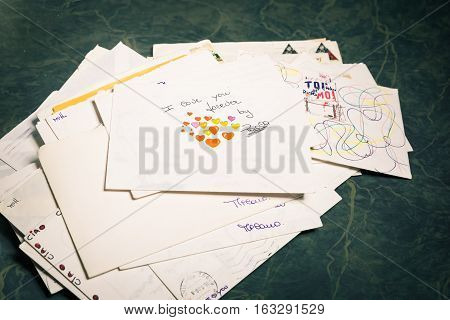 Big stack of mails pile of papers or heap of letters above a letter saying 