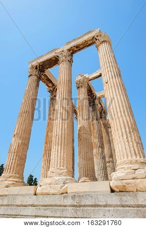 Looking up view of famous Greek temple pillars against clear blue sky in Temple of Zeus Greece