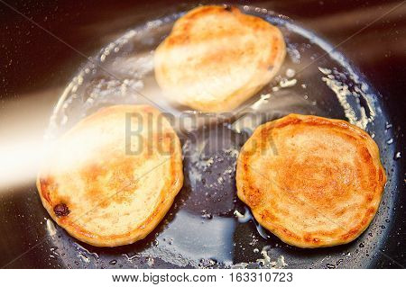 fried fritters in oil in a frying pan