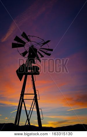 Old Windmill with Sunset Portrait.  Windmill is backlit
