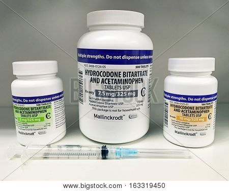 Ogden, Utah USA-July 22, 2016: Norco and hydrocodone bottle of different strengths with needle to illustrate drug abuse and drug use