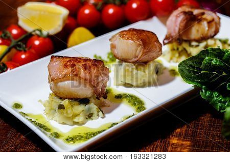 Seared scallops wrapped in panchetta, dill mouli mash and lemon curd drizzle