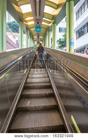 Hong Kong, China - December 4, 2016: People use the Central Mid Levels escalator in Hong Kong, the longest outdoor covered escalator system in the world, to move from Central to Western District.