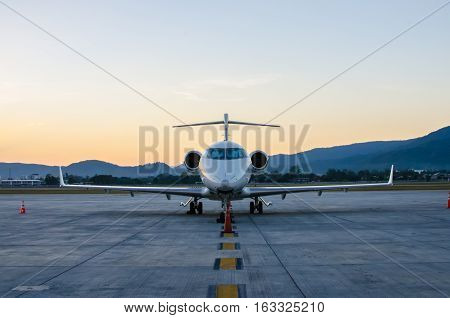 Small Airplane or Aeroplane Parked at Airport.Small Airplane Famous to use Private Airplane.Sunset Light and Mountain View.