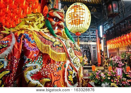 God statue in traditional old oriental chinese temple in Taiwan (Chinese Translation on lantern : name of the chinese god of sea mazu(matsu))