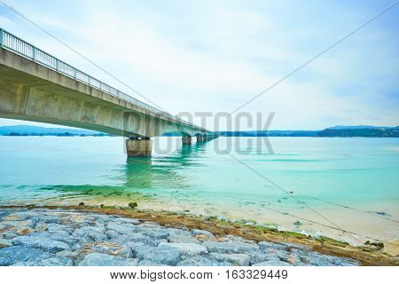 Kouri island bridge with beautiful sea level with blue sky in Okinawa Japan