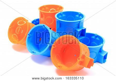 Stack Of Orange And Blue Electrical Boxes. White Background