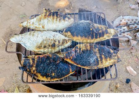 The Thailand style burn or adust grilled fishes in the charcoal grill.