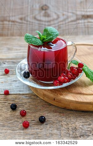 Kissel Of Red And Black Currants With Sprig Of Mint.