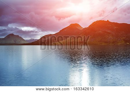 Lake coast with mountain reflection at the sunrise, Iceland. treking in Iceland. Travel concept.