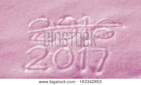 Words 2017 and 2016 hand drawn in fresh snow