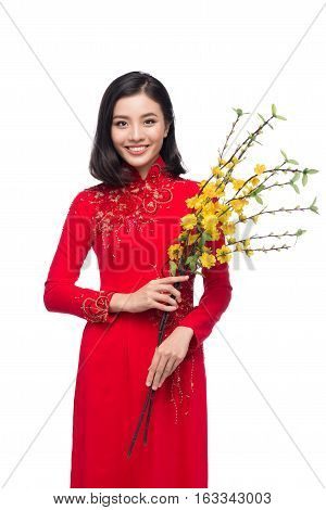 Portrait Of A Beautiful Asian Woman On Traditional Festival Costume Ao Dai Holding Hoa Mai Tree (och