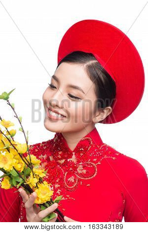 Portrait Of A Beautiful Asian Woman On Traditional Festival Costume Ao Dai Holding Hoa Mai Tree (och