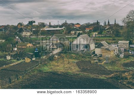 Old film stylized photo of rural village in central Ukraine