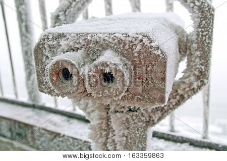 Coin operated binoculars for observation of Vienna covered by snow and ice in the winter