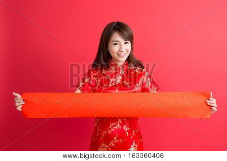 beauty woman wear cheongsam and show couplets with chinese new year