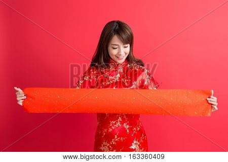 beauty woman wear cheongsam and show couplets with chinese new year