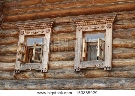 Decorated wooden windows with traditional carving ornament, Moscow, Ethnomir park, June 2016